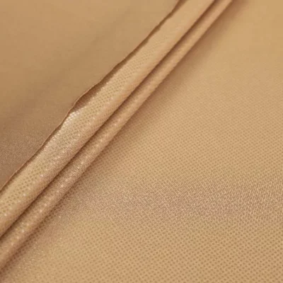 Clear dot metallic spandex in dark nude — wholesale stretch fabric