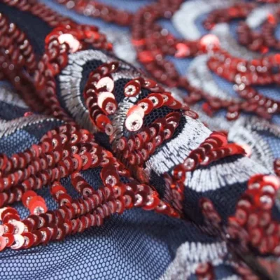 Red embroidery spandex sequins on black mesh — wholesale fabric