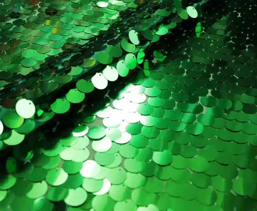 IMG_2750 Reflective iridescent teardrop paillette sequins on stretch mesh in kelly green — wholesale fabric