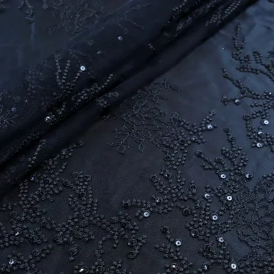 Black floral embroidered sequins on tulle mesh — wholesale fabric