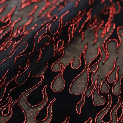 Flame flocking mesh glitter spandex in red, black, and black — wholesale fabric