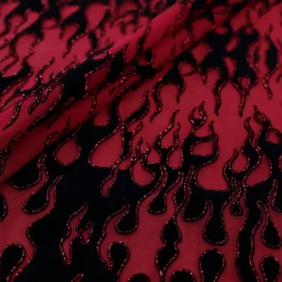 Flame flocking mesh glitter spandex in red, black, and red — wholesale fabric