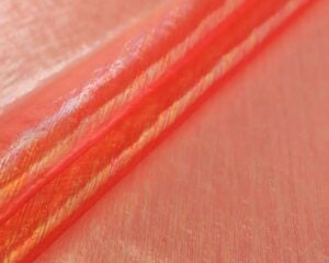 Sheer iridescent fabric in opalite orange — wholesale stretch fabric