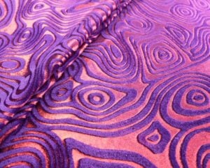 Intricate folds velvet stretch foil in red and purple — wholesale fabric