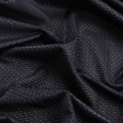 Close-up of dark navy perforated athletic mesh fabric