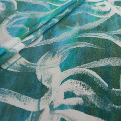 Teal and white swirl patterned fabric close-up